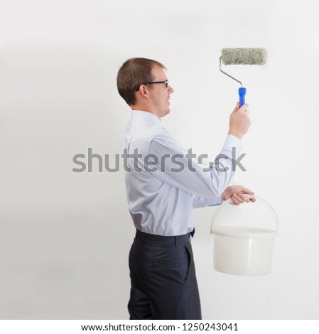 Business man painting  with roller paint. businessman holding bucket isolated on white background. 