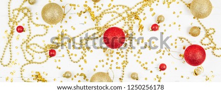 New Year or Christmas pattern flat lay top view Xmas holiday celebration decorative golden toy balls sparkles white wooden background copy space Template frame for greeting card your text design