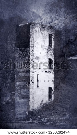 The ruins of the tower on the background of winter forest mountains. Picturesque ruins in retro style photo
