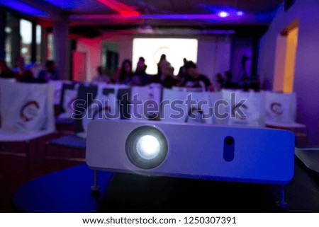Close up projector in conference room with blurry background