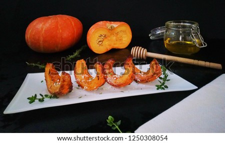 Pumpkin. Slices of baked pumpkin with Provencal herbs, honey and sesame. Proper nutrition. Healthy and tasty snack (Appetizer). Ideas and recipes for a healthy breakfast, dinner. Selective focus.