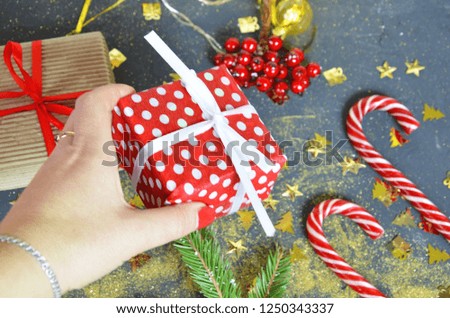 The New Year card is decorated with golden serpentine, stars, celebrate the holiday, party, confetti, caramel cane, Christmas tree, red berries on a black background. Happy New Year and Merry