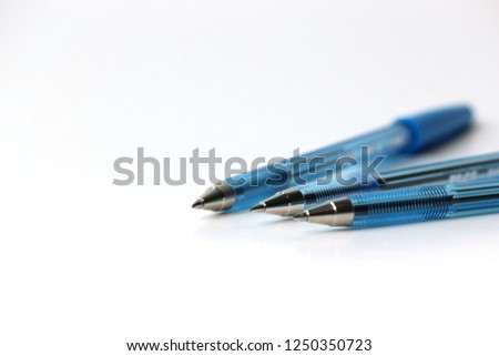 Blue Pens on White Background for Office, Business, School, Planning, and Writing Images Royalty-Free Stock Photo #1250350723