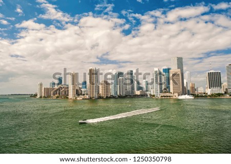 Aerial view of Miami waterfront skyline downtown at sunny day. Florida speedboat sailing next to port