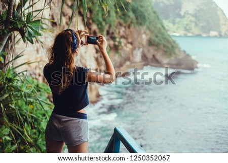 Young girl make photo in smartphone camera, digital frame, social blogger, outdoor hipster portrait, travel woman, paradise island, ocean, freedom