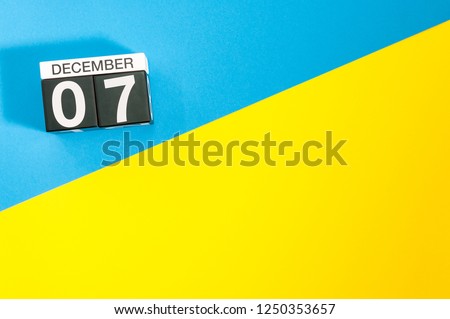December 7th. Image 7 day of december month, calendar on blue-yellow background with empty space for text, mockup