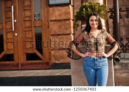 Pretty latino model girl from Ecuador wear on jeans posed at street. 