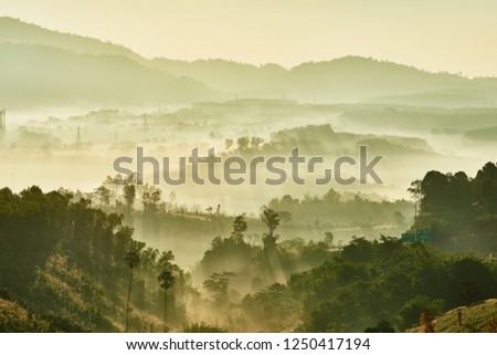 Tropical nature landscape mountains forest with slightly fog in morning and sunlight, Thailand.