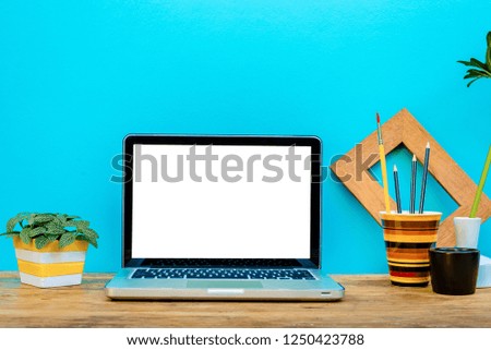 Mockup laptop with decorative website designer stationery for business workspace.