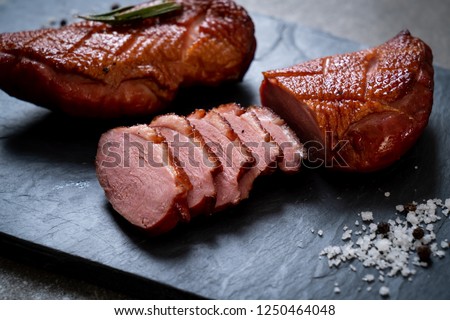 grilled duck breast on black slate plate
