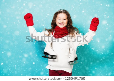 A portrait of a pretty young girl with skates. Winter fashion for kids, beauty, active and healthy lifestyle.