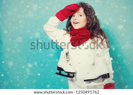 A portrait of a pretty young girl with skates. Winter fashion for kids, beauty, active and healthy lifestyle.