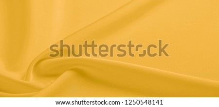 background texture, pattern. Yellow silk fabric. A very light faux dupioni silk fabric with rich drape and slub texture with a subtle matte sheen. It is perfect for your design accents.