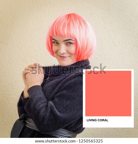 beautiful woman with hair colored in a color of 2019 Living Coral 