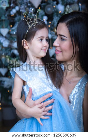 Christmas. new year. Mom and daughter Princess at the Christmas tree