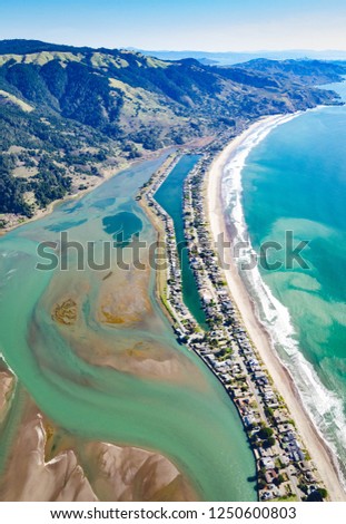 Aerial photo taken over Stinson Beach, CA during summer with Mt. Tam and San Francisco in horizon.