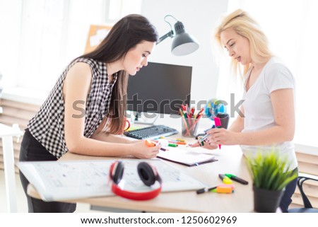 Two girls work in the office.