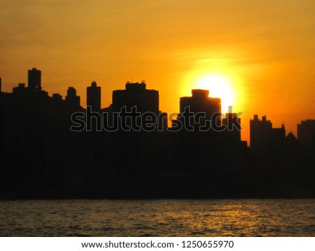 Silhouette of Victoria Harbour, Hong Kong, during sunset                               