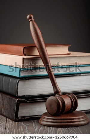 Books and a judge's gavel on wooden table. Juridical science and legal studies concept.