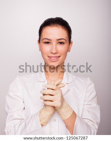 the young and beautiful doctor in a  rubber gloves