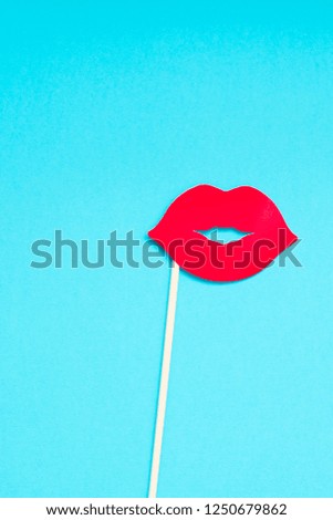 Creative overhead top view retro stylish red paper photo booth props female lips turquoise background copy space. Birthday parties and weddings valentine day template