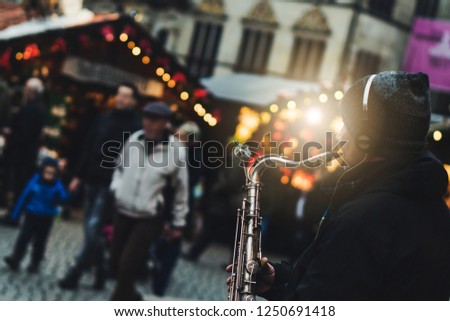 Blur background with bokeh of christmas light in europe germany christmas market, xmas and new year winter festival. Young kids happy enjoy smile snow, tree, toy, shop, food, candy in fair in holiday