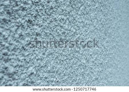 Texture of fine plaster on concrete wall background with shallow depth of field
