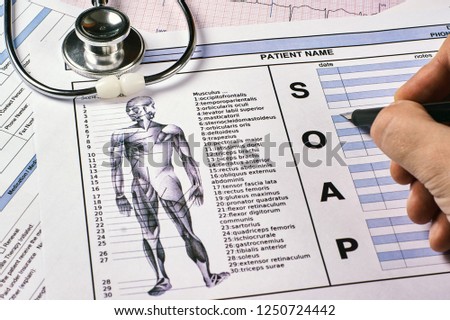 Human fill a Patient SOAP note sheet, stethoscope on corkwood background. Flat lay. Royalty-Free Stock Photo #1250724442