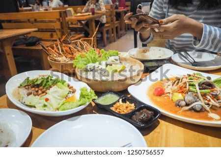 Woman hands make photography of food with phone. Thai food.