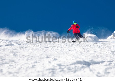Man skiing on the prepared slope with fresh new powder snow. 