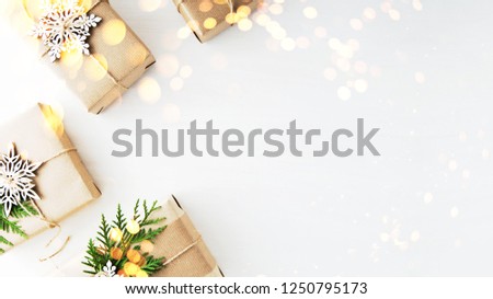 Merry Christmas and Happy Holidays greeting card, frame. New Year. Christmas gifts, presents, fir tree and ornaments on white background top view. Winter holiday xmas theme. Noel. Flat lay.