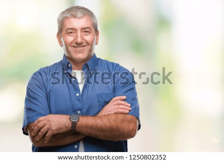 Handsome senior man over isolated background happy face smiling with crossed arms looking at the camera. Positive person.