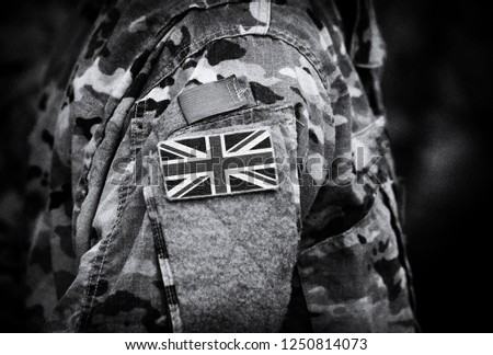 Flag of United Kingdom on soldiers arm. Flag of UK on military uniforms (collage).