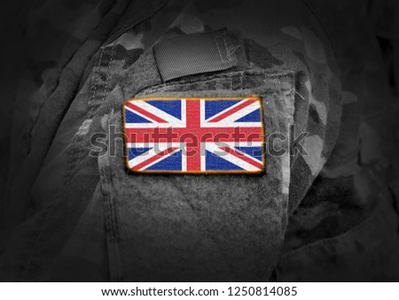 Flag of United Kingdom on soldiers arm. Flag of UK on military uniforms (collage).