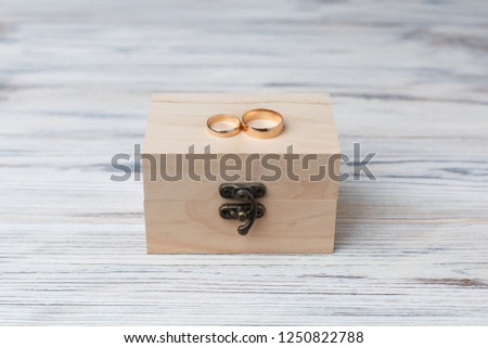 two golden wedding rings in wooden box with copy space for text close up. wedding rings isolated  on wooden background. wedding day. wedding details. love story concept. 