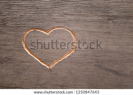 Heart carved on the wooden plank.  Cuttings from wood.  Valentine's Day. A symbol of love. A pattern on the tree.  Royalty-Free Stock Photo #1250847643