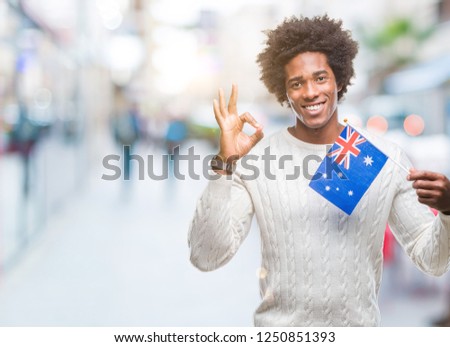 Afro american man flag of Australia over isolated background doing ok sign with fingers, excellent symbol