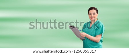 Portrait of female doctor holding a clipboard on green background