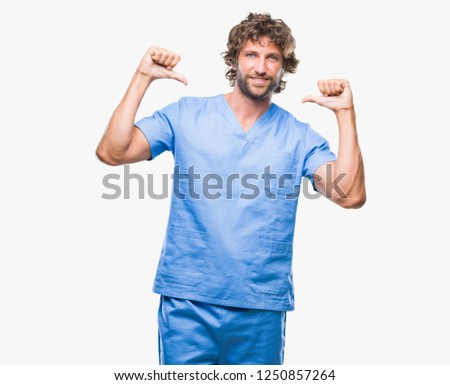 Handsome hispanic surgeon doctor man over isolated background looking confident with smile on face, pointing oneself with fingers proud and happy.