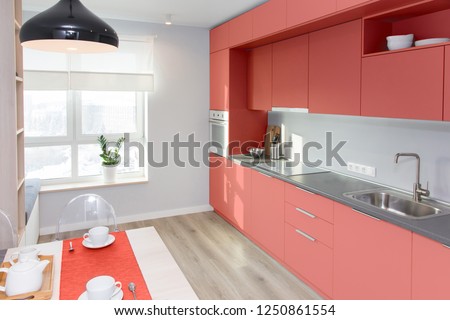 Kitchen interior in light colors. Scandinavian style. color of the year 2019 living coral pantone Royalty-Free Stock Photo #1250861554