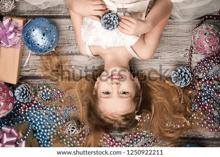 cute little girl lying in the Christmas decorations