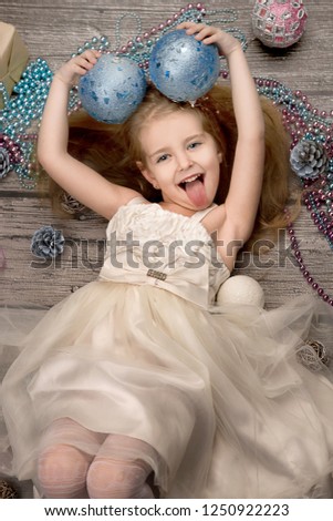 cute little girl lying in the Christmas decorations