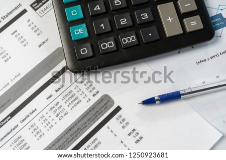 Concept of paying bills. Close up cropped photo with flat lay high angle above top view of object blank calculator and pen
