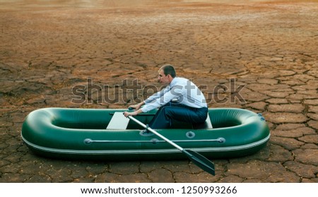 Business man will row home for shore in paddle powered row boat.businessman rock look bright future symbol crisis stagnation losses braking difficulties environmental disaster water scarcity drought