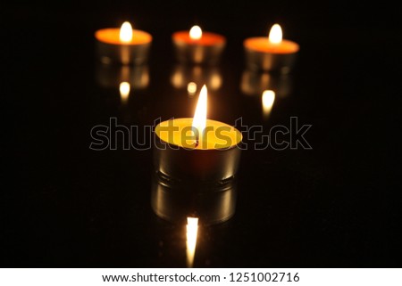 Burning candles on a dark background