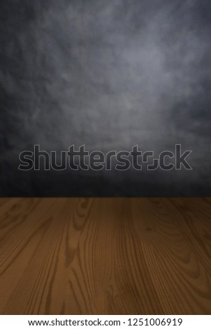 Photoshoot studio backdrop, with a wooden table and grey wall ready for a pack shot or product display