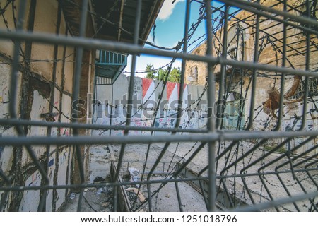 Palestine, West Bank, Hebron 10/19/16 :Israeli West Bank barrier. The Apartheid Wall in Hebron Which separates old city about shuhada street. Blocked road exit in (Translation: Palestine)