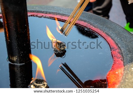People burn the incense stick in temple.