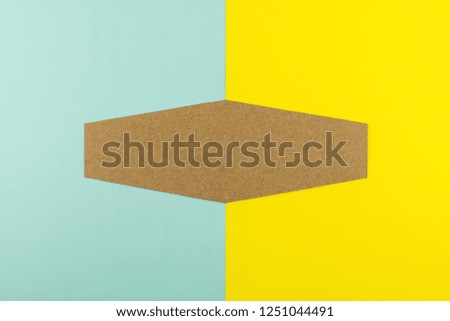 Hexagon brown paper on blue and yellow paper background. - space for your text