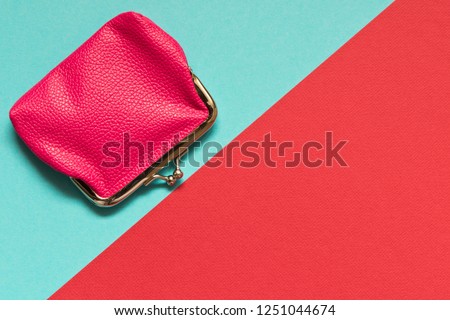 Pink wallet on blue red background . Saving concept.